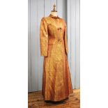 A Princess Lucie, floor length evening coat of apricot/gold metallic brocade, with woven pattern,