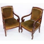 A pair of William IV carved mahogany library chairs, with green upholstery and scroll end arms,