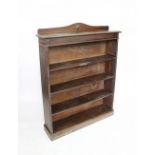 A 1920's oak dwarf open bookcase, with four shelves on plinth base,