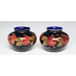 A pair of Moorcroft Pomegranate and Berries squat vases,