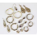 A collection of gold and other assorted earrings,