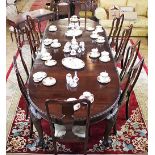 A 1920's oval mahogany extending dining table, with a moulded edge,