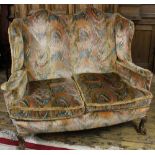 A 1920's Queen Anne style two seater sofa, on cabriole legs and claw and ball feet,