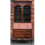 A 1920's mahogany bureau bookcase, on cabriole legs,