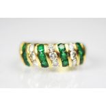 A diamond and emerald 18ct gold ring,