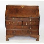 A George III and later oak bureau, with fall over two short and two long drawers, on bracket feet,