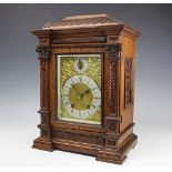 A late Victorian eight day carved oak mantle clock,