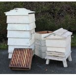 A vintage seven section painted pine bee hive, 127cm, with a smaller bee hive,