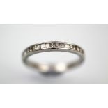 A diamond set half eternity ring, the platinum band set with eighteen princess cut diamonds,