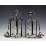 A pair of gilt brass cylindrical hall lanterns, with three glass panels,