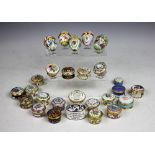 A collection of twenty six Halcyon Days enamel boxes, to include; five egg shaped examples,