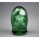 A 19th century green glass dump paper weight, with nine internal flowers, 14.