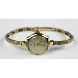 A 9ct gold ladys Vertex wristwatch, the circular champagne dial with gilt Arabic numerals,