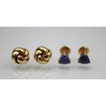 A pair of tanzanite set stud earrings, each designed as a triangular cut tanzanite,