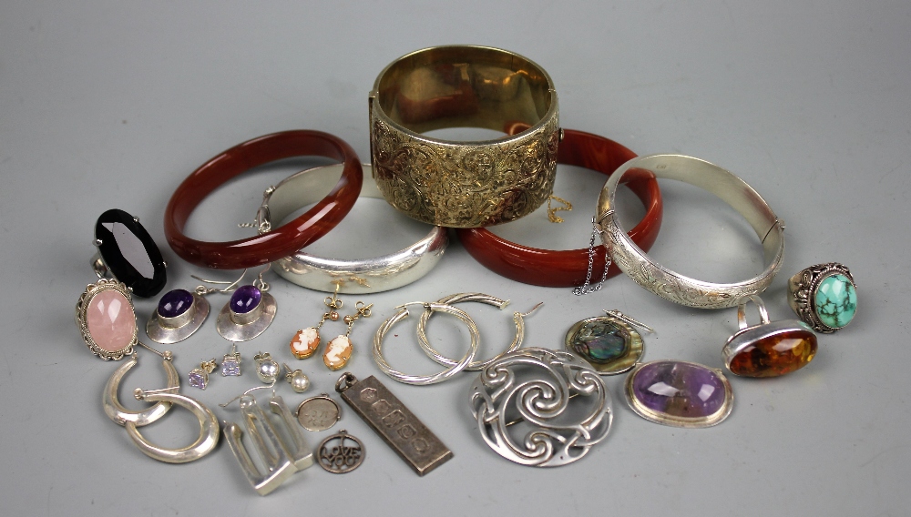 A collection of assorted silver bangles and jewellery to include earrings, an ingot,