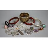 A collection of assorted silver bangles and jewellery to include earrings, an ingot,