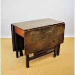 A George III provincial oak gate leg table, with three plank top, on square legs,