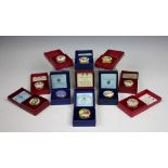 A collection of eleven Halcyon Days, Bilston enamel Christmas boxes to include; 1976, 1977, 1978,