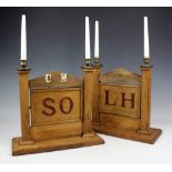 A pair of masonic light oak candle stands,