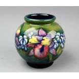 A Moorcroft vase, the ovoid vase decorated in a the iris pattern with a continuous band of blooms,