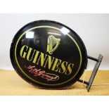 A Guinness oval double sided advertising sign / wall bracket,