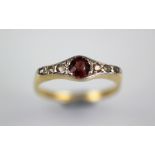 A garnet and diamond ring, the central garnet flanked by three rose cut diamonds to either side,