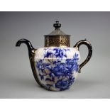 A Royal Doulton Burslem patent self pouring teapot, with flow blue floral detailing and pewter lid,