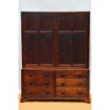 An early 19th century mahogany and pine housekeepers cabinet of large proportions,