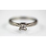 A solitaire diamond ring, the single princess cut diamond,