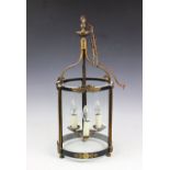 A gilt brass cylindrical hall lantern, with reeded and foliate detailing,