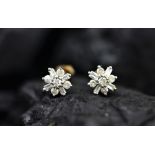 A pair of diamond set stud earrings,