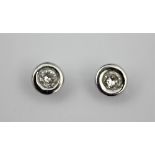 A pair of diamond set stud earrings,