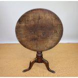 A George III and later oak occasional table, with tilt top, on turned column and tripod base,