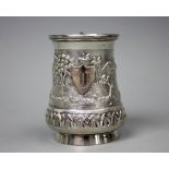 A Burmese silver mug, embossed with landscape scenes of agriculture,