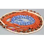 A coral coloured graduated bead necklace,