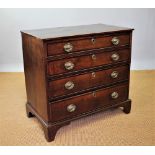 A George III oak and mahogany cross banded chest, of four graduated long drawers, on bracket feet,