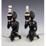 A pair of mid-century design figural lamp bases, each modelled as nude female attendants, Reg No.