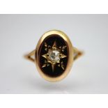 A diamond set ring, 19th century, designed as an oval disc set with a central old cut diamond,