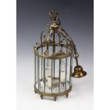 A gilt brass cylindrical hall lantern, with scroll top and sixteen bevelled glass panels,