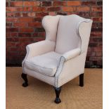 A George II style wing back library chair, with patterned pale upholstery,