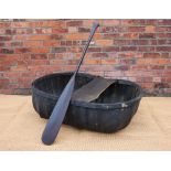 A vintage Welsh coracle, 95cm x 123cm, with a stained pine paddle,