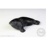 An Inuit soapstone walrus carving, engraved 'E91585' and initialled,