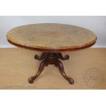 A Victorian walnut oval loo table, with baluster column, on scroll legs,