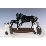 A Royal Doulton black beauty mare and foal group, upon oval base, 20cm high,