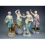 A set of four late 19th century continental porcelain male and female figures emblematic of the