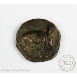 A large Greek or Republican Roman bronze coin, one side decorated with a boar,