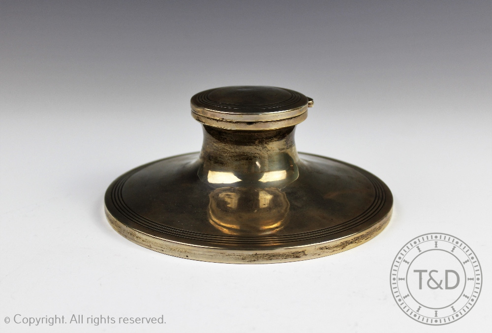 A George V large silver capstan ink well, Birmingham 1925, with reeded decoration, with liner,