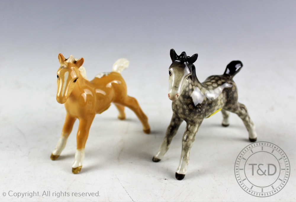 Two Beswick foals (small, stretched, facing left), model number 997, designed by Arthur Gredington,