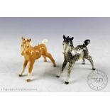 Two Beswick foals (small, stretched, facing left), model number 997, designed by Arthur Gredington,