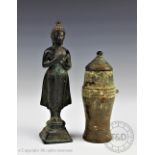 A Thai/Laos bronze figure of a female deity, modelled standing upon a lotus crown base,